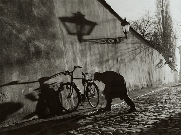 Untitled (Man Repairing Bicycle Tire)