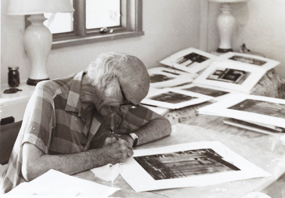 Portrait of Beaumont Newhall with Photographs