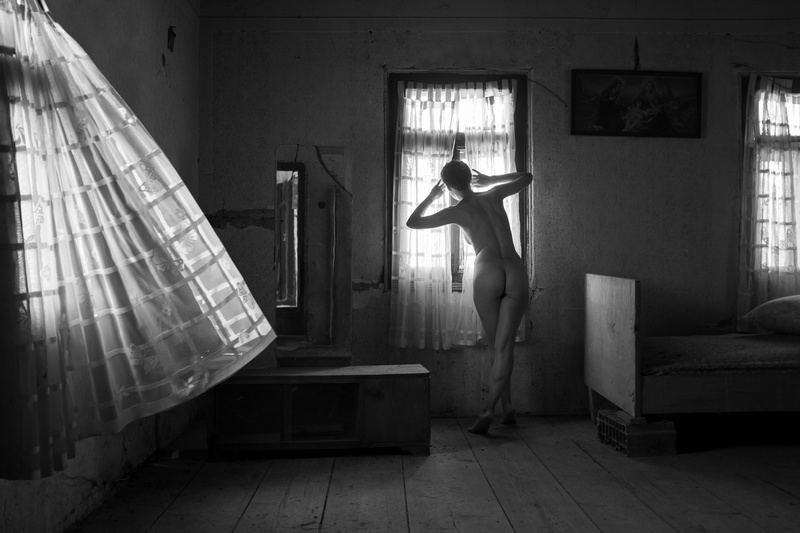 Female Nude Peeking through Drapes