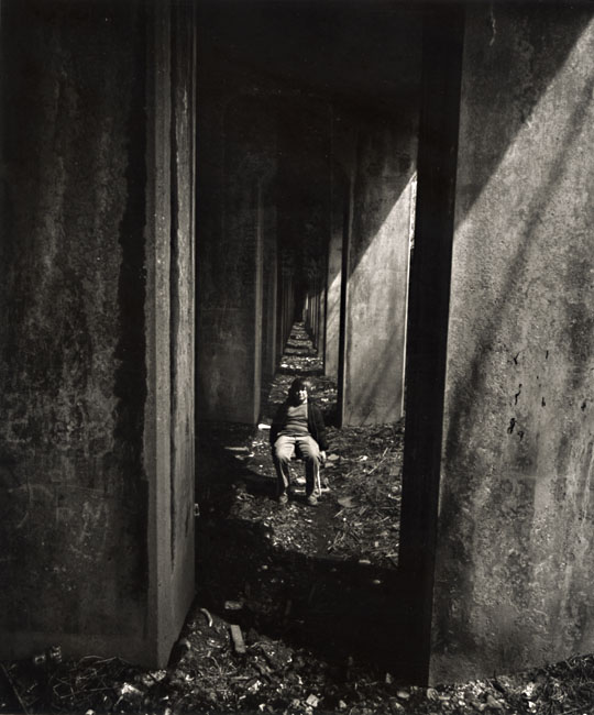 A Boy Sits under an Abandoned Railroad Track, Staten Island, NY
